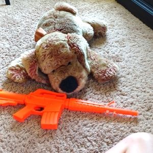 A dog and a gun fake toy